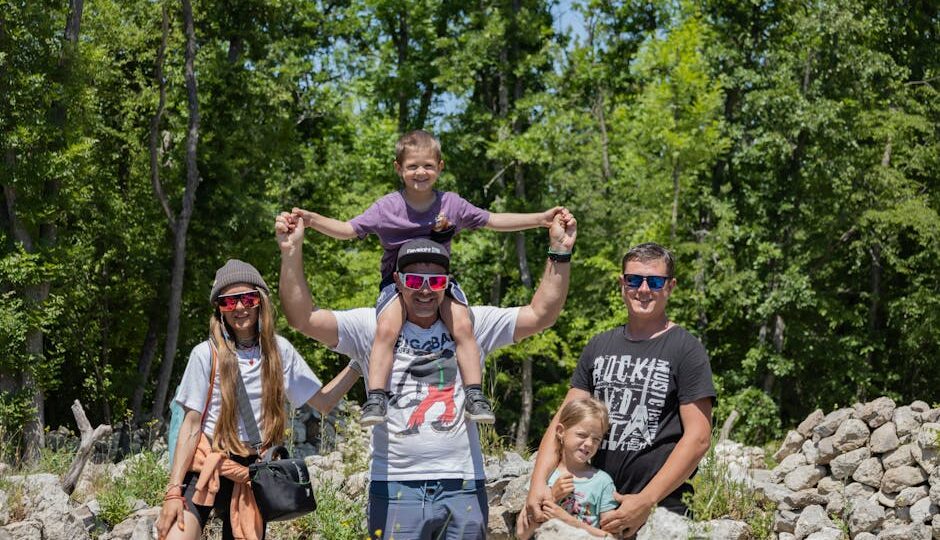 A joyful family enjoying a sunny day outdoors, captured in a lively and happy moment.
