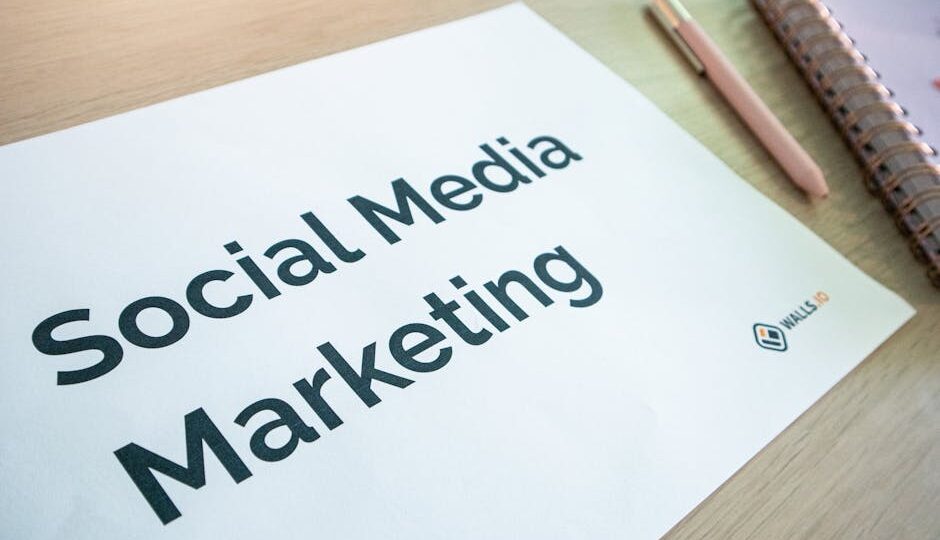 Close-up of a social media marketing document on a desk with a pen and notebook.
