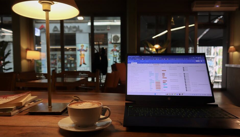 Relaxing café scene in Istanbul featuring a cappuccino and laptop on a wooden table.