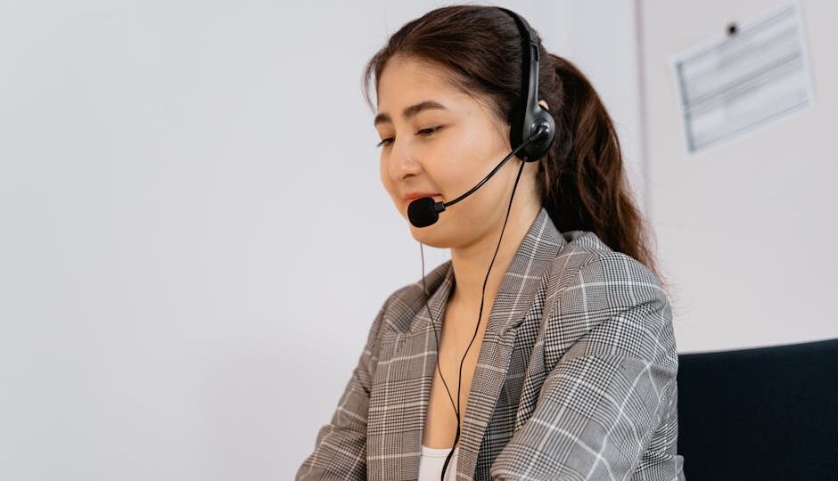 Professional woman providing customer support, wearing headset in office.