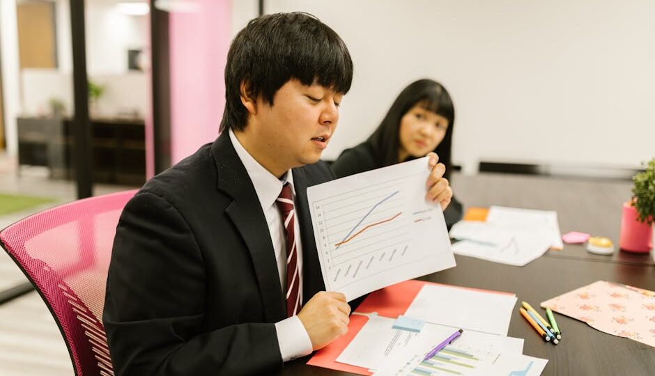 Business professionals discussing data during a meeting in a modern office.