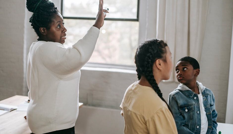 Teacher and students engaged in a learning session indoors with focus and interaction.