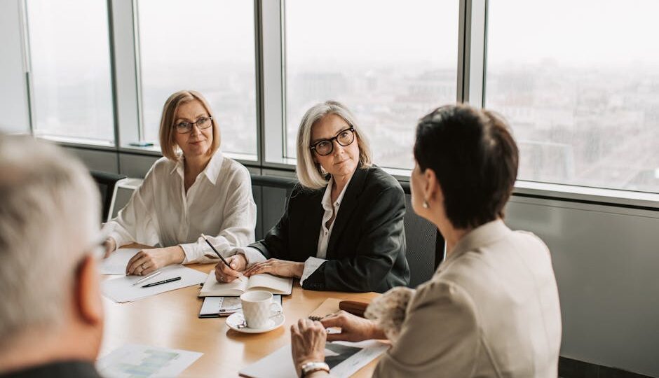 Business professionals engaged in a strategy meeting in a contemporary office. Daytime setting.