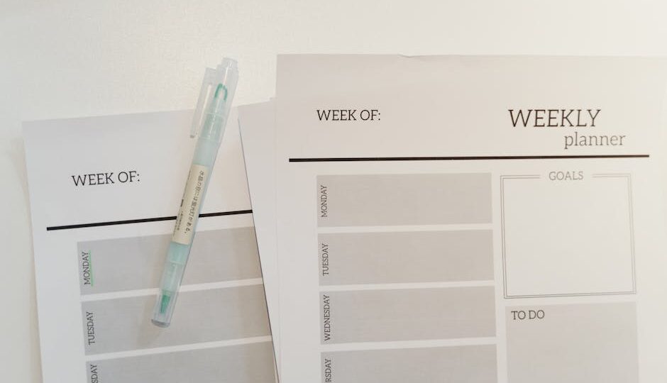 Organized weekly planner sheets with a pen for efficient scheduling and goal setting.
